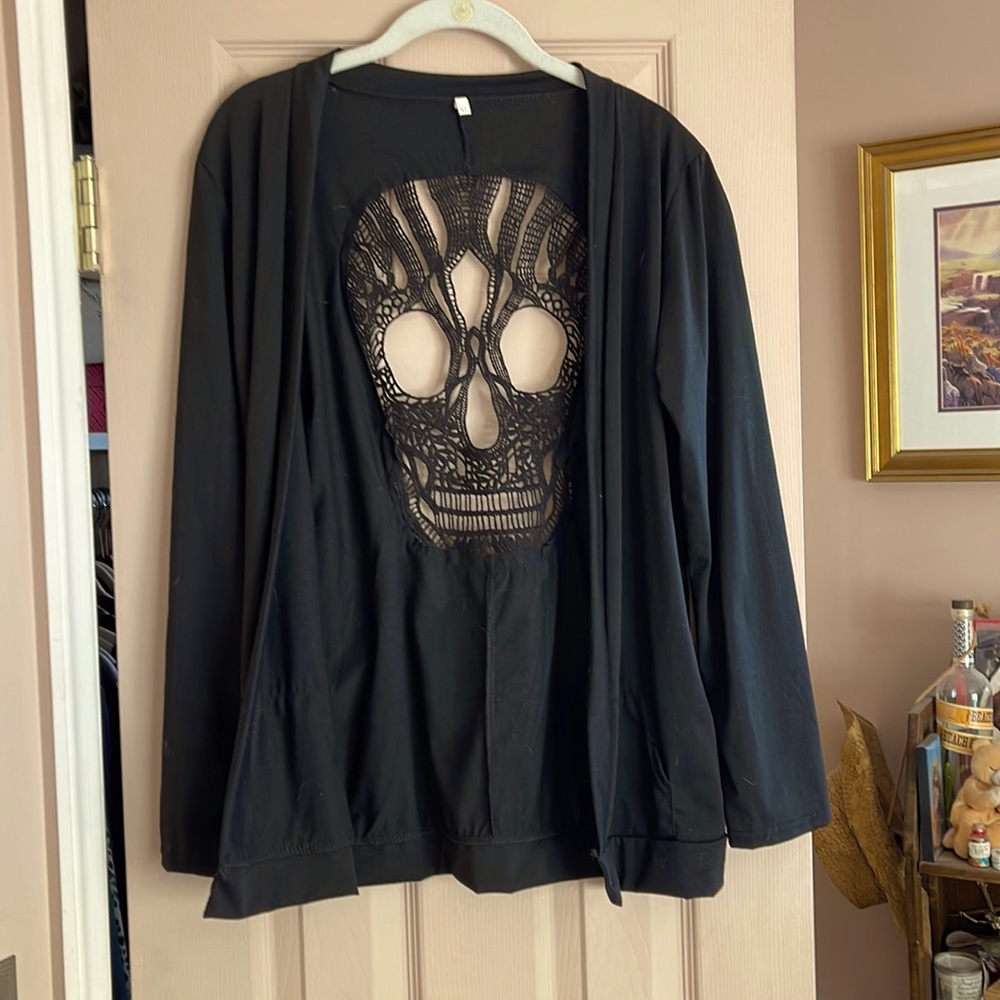 Lightweight jacket to be worn over solid top. Great skull cut out.